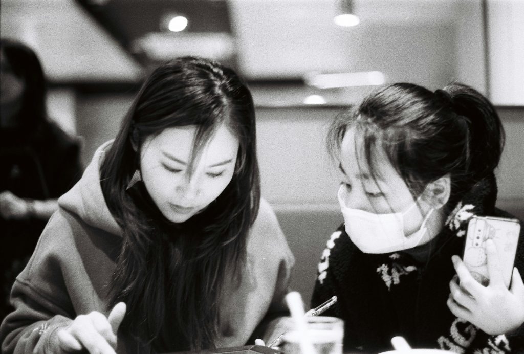 frau-in-schwarz-weissem-geblumtem-armellosem-kleid-PRShf1leObk