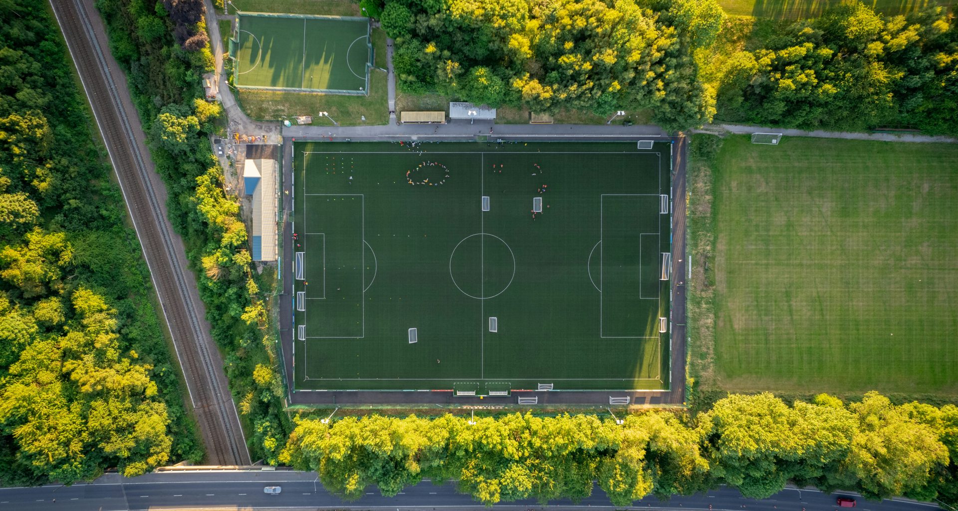 ein-grunes-gebaude-mit-einem-schild-umgeben-von-baumen-TgAOYzHDfMc