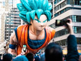 a-large-balloon-of-a-dragon-is-being-held-up-in-the-air-YavHUvSfOQw