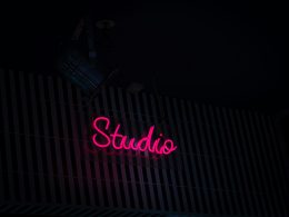 eine-leuchtreklame-mit-der-aufschrift-studio-an-der-seite-eines-gebaudes-FaYZbfPeqVE
