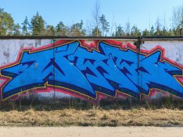 blaue-rote-und-schwarze-graffiti-kunst-an-der-wand-12pjdR0DNEw