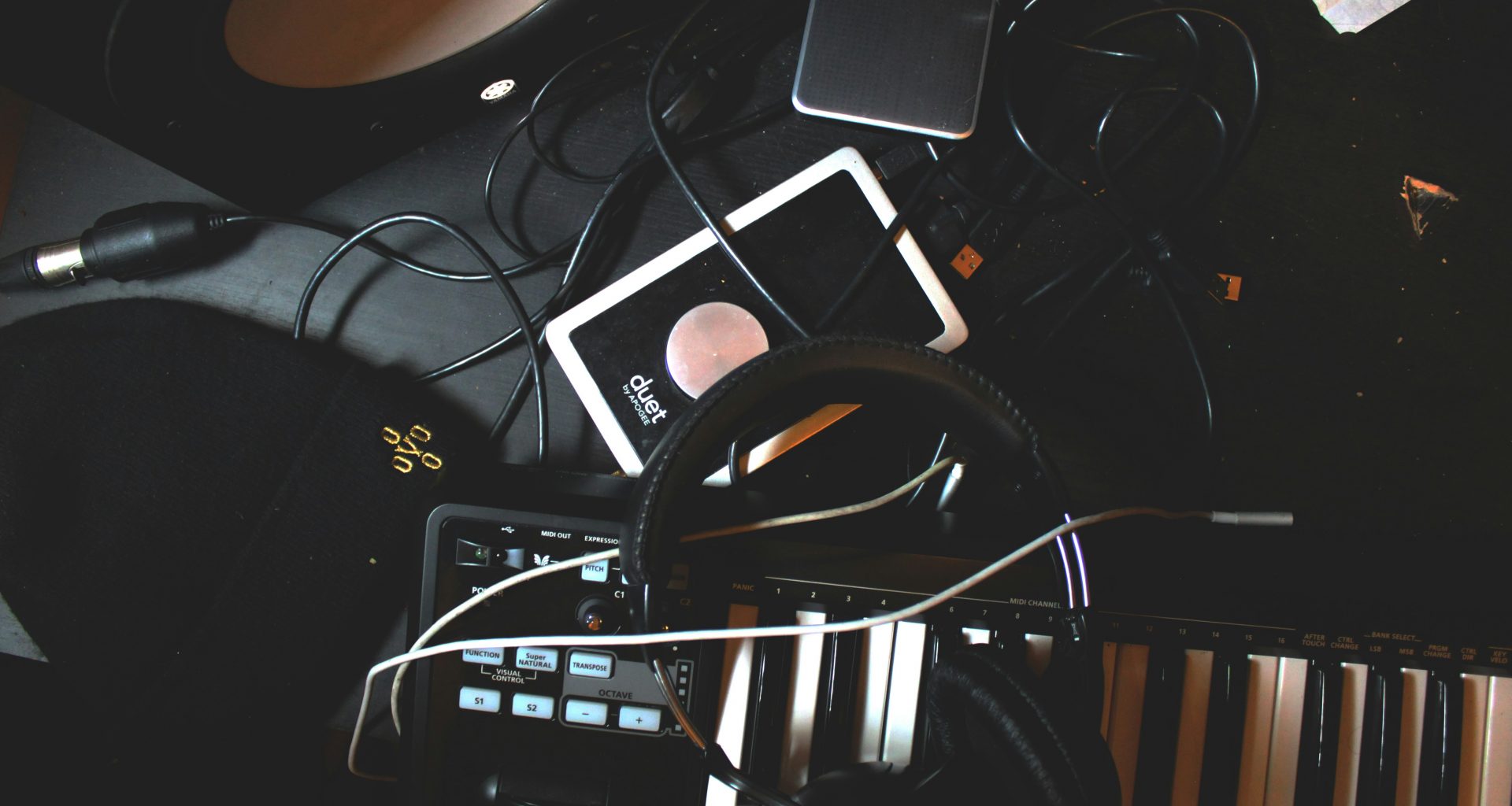 flat-lay-foto-von-kopfhorern-midi-keyboard-und-lautsprecher-auf-schwarzer-oberflache-k3heD_KwH0A