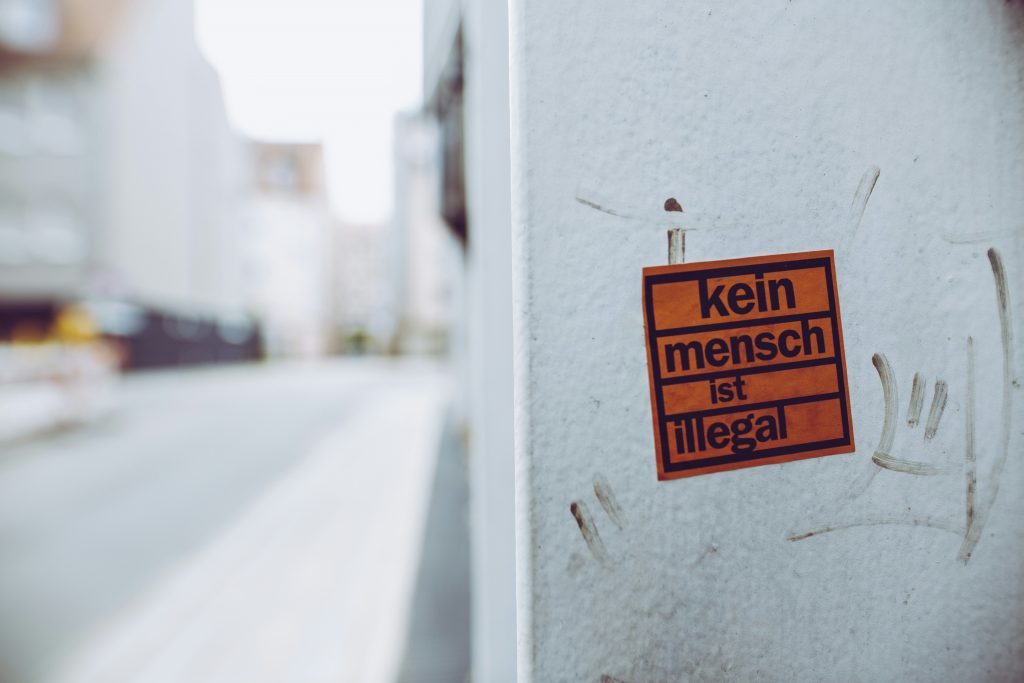 kein-mench-ist-illegal-sign-sticker-XcWtrmI6mpg