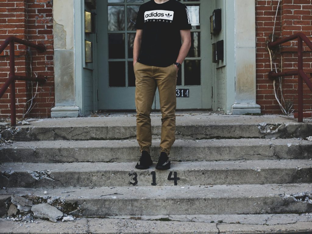 mann-legte-seine-hand-auf-seine-tasche-wahrend-er-auf-der-treppe-stand-wtjhLcxLDoQ