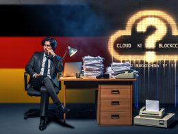 Geschäftsperson am überfüllten Schreibtisch mit alter Faxmaschine, leuchtendem Laptop, Papierstapeln und einem digitalen Fragezeichen; im Hintergrund eine deutsche Flagge und Neonbegriffe wie Cloud, KI und Blockchain.