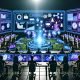 Futuristischer Kontrollraum mit Marketingexperten, die holografische Dashboards zu KI-Dialoganzeigen, Analysen und Benutzerprofilen untersuchen. Neonfarben, Gesprächsblasen und NLP-Symbole visualisieren innovative Werbetechnologien.