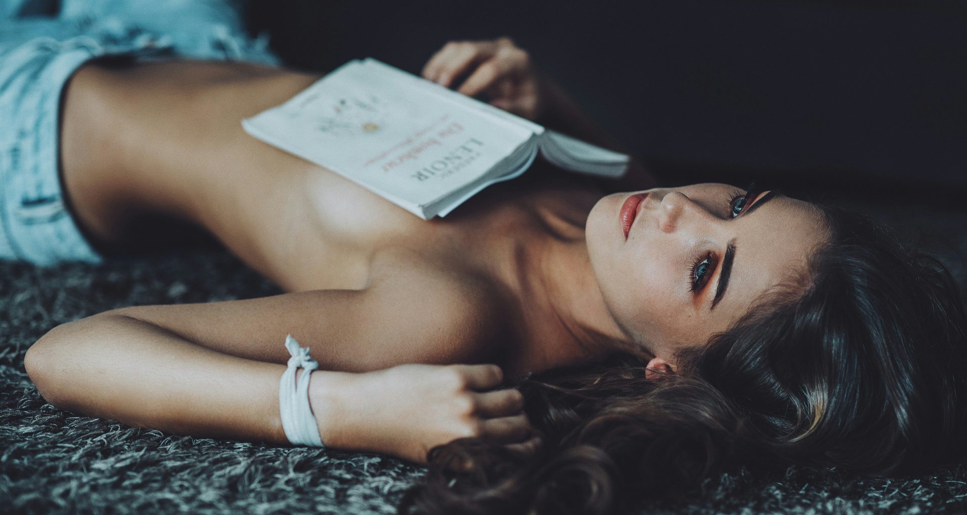 topless-woman-lying-on-ground-while-holding-white-book-rg29IYzdPlo