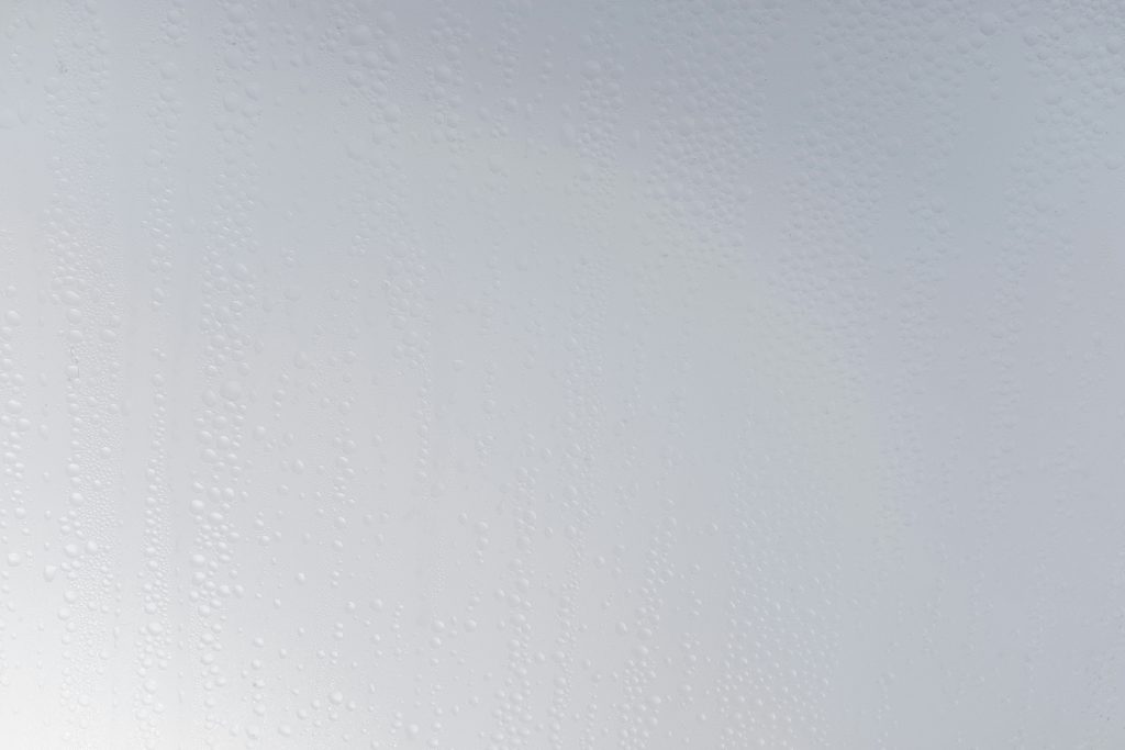 eine-weisse-wand-mit-wassertropfen-darauf-AKHh5Vie5AU