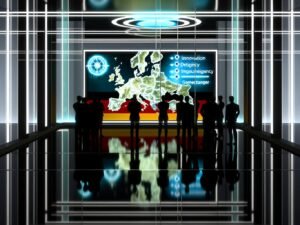 Beamte in einem modernen Konferenzraum analysieren eine digitale Karte von Deutschland mit cyberbezogenen Grafiken, während Präsentationsfolien Innovation, Souveränität und Gamechanger betonen.