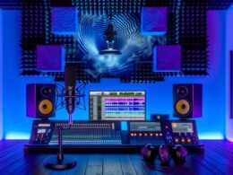 Futuristisches Tonstudio mit Ambisonics-Mikrofon, binauralem Dummy-Head-Mikrofon, High-End-Kopfhörern und großen Bildschirmen mit 3D-Audio-Wellenformen in moderner, blau-violetter Umgebung.