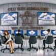 Modernes Büro mit erschöpftem Marketingteam vor Bildschirmen und cloudbasierter Video Content Automation-Lösung im Hintergrund