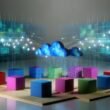 Modernes Büro mit bunten, isolierten Datenwürfeln auf Podesten, getrennt durch digitale Mauern und leuchtende, unterbrochene Datenverbindungen. Im Hintergrund verbindet ein Netzwerk aus Datenelementen alles dynamisch.