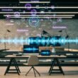 Futuristischer Loft-Arbeitsplatz mit stilvollem Schreibtisch, mehreren Monitoren mit Audiowellen, Transkriptionssoftware, API-Diagrammen und schwebenden Begriffen wie Innovation und KI.