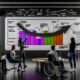 Team aus drei Personen, darunter eine Frau, ein Mann mit Bart und eine Person im Rollstuhl, analysieren gemeinsam ein digitales Marketing-Dashboard mit markierten Peak-Ereignissen in einem modernen, inklusiven Büro.