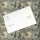Eine Apple Card liegt auf mehreren Hundert-Dollar-Scheinen und symbolisiert digitale Bezahllösungen im Finanzsektor.