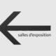 Schwarzer Schriftzug 'salles d'exposition' vor minimalistischem, hellen Hintergrund in einer modernen Ausstellung.