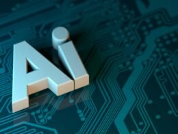 Buchstabe A liegt mittig auf einer grünen Leiterplatte mit elektronischen Bauteilen im Hintergrund.