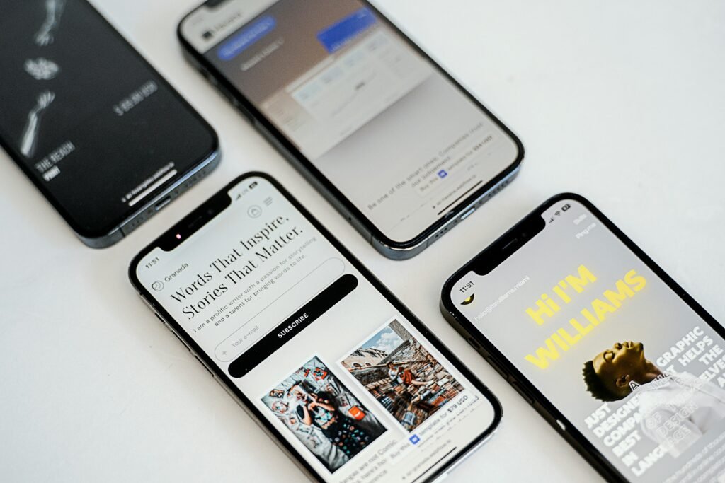 Drei verschiedene Smartphones liegen nebeneinander auf einer glatten Oberfläche und zeigen unterschiedliche Designs und Größen.