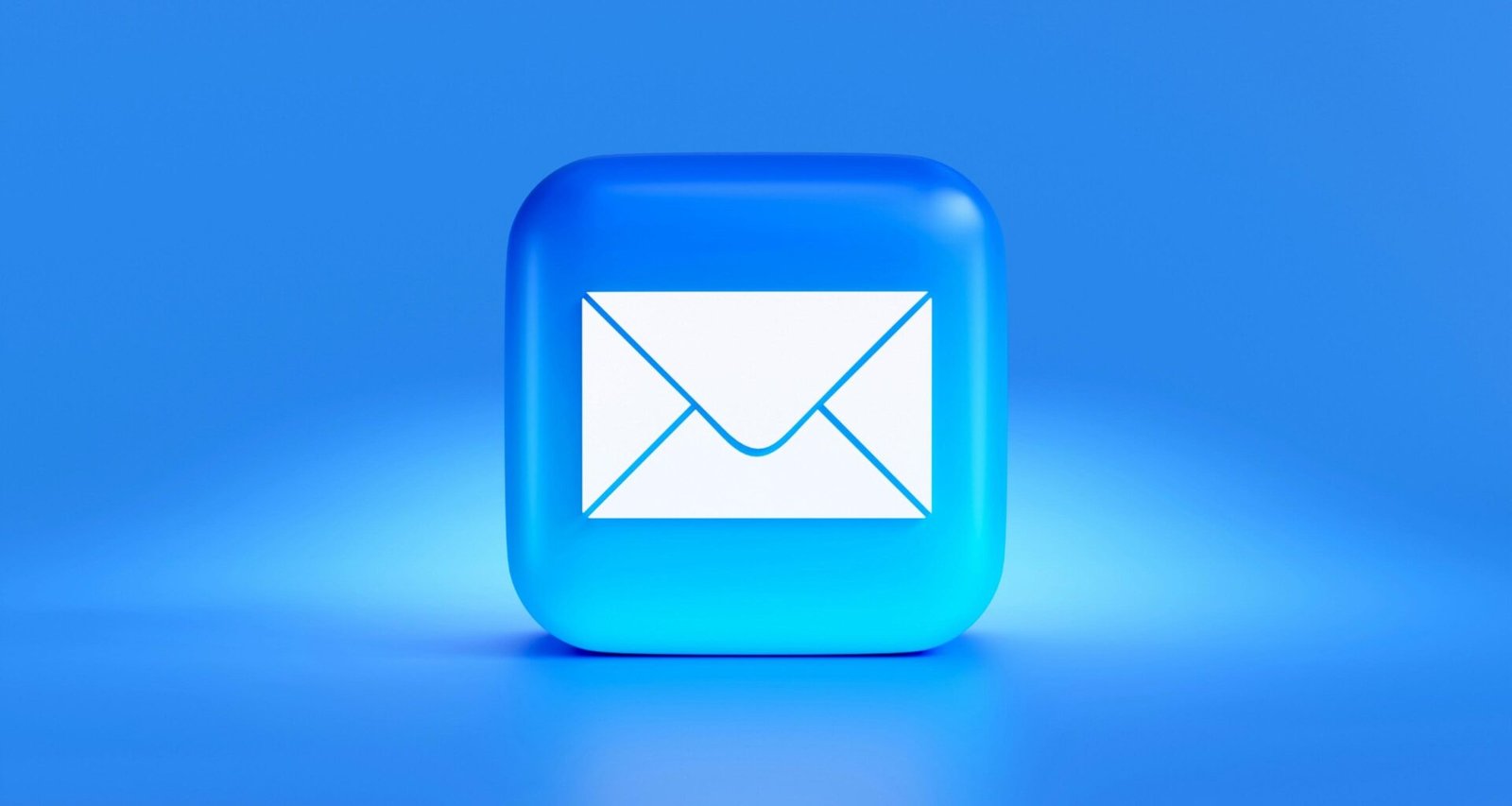 Nahaufnahme eines blauen Buttons mit einem weißen Briefsymbol, das auf digitale E-Mail-Kommunikation hinweist