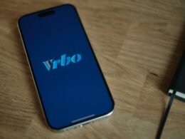 Ein modernes Smartphone liegt auf einer Holzoberfläche, perfekt für Artikel über mobile Technologien und digitale Geräte.