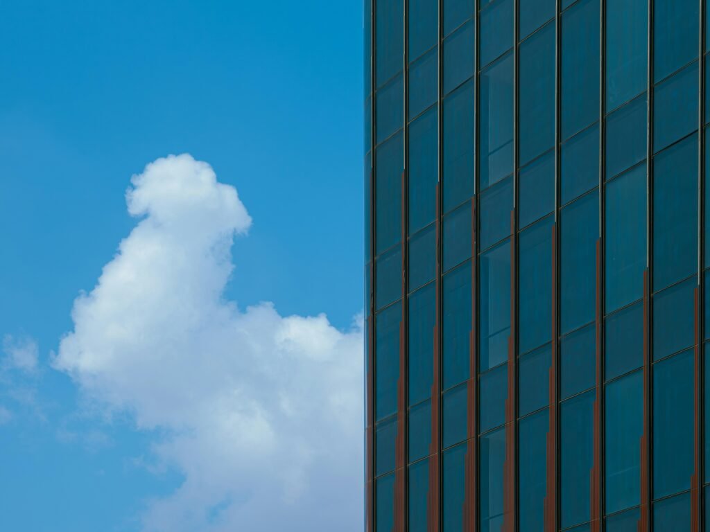 Ein hohes modernes Gebäude erhebt sich vor einem klaren Himmel, Detailaufnahme der Architektur und Struktur der Fassade.