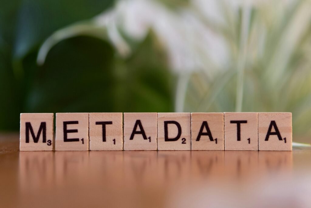 Holzblock mit dem Aufdruck 'metadata' auf einem Tisch als Symbol für Datenorganisation und SEO-Grundlagen.