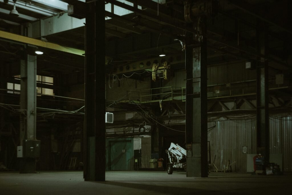 Ein Mann fährt auf einem Motorrad eine Straße entlang, flankiert von hohen Gebäuden und moderner Architektur.