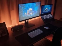 Ein Schreibtisch mit einem Computer und einem Laptop, ausgestattet für zeitgemäßes Arbeiten in einem modernen Büro.