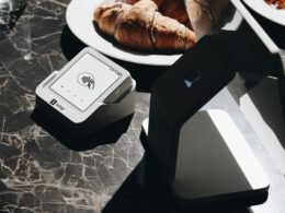 Ein gedeckter Tisch mit Tellern voller Speisen und einem Laptop, arrangiert als Arbeitsplatz und Essplatz zugleich