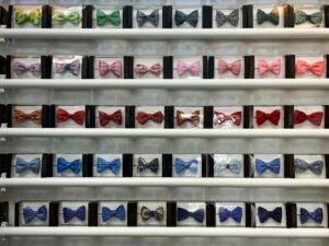 Mehrere verschiedenfarbige Fliegen nebeneinander angeordnet, jede Fliege in einer anderen kräftigen Farbe, als modische Accessoires