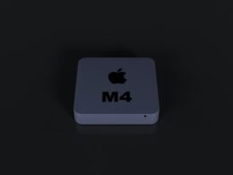 Nahaufnahme eines beleuchteten Apple Logos auf schwarzem Hintergrund, aufgenommen von oben in moderner Studioumgebung.