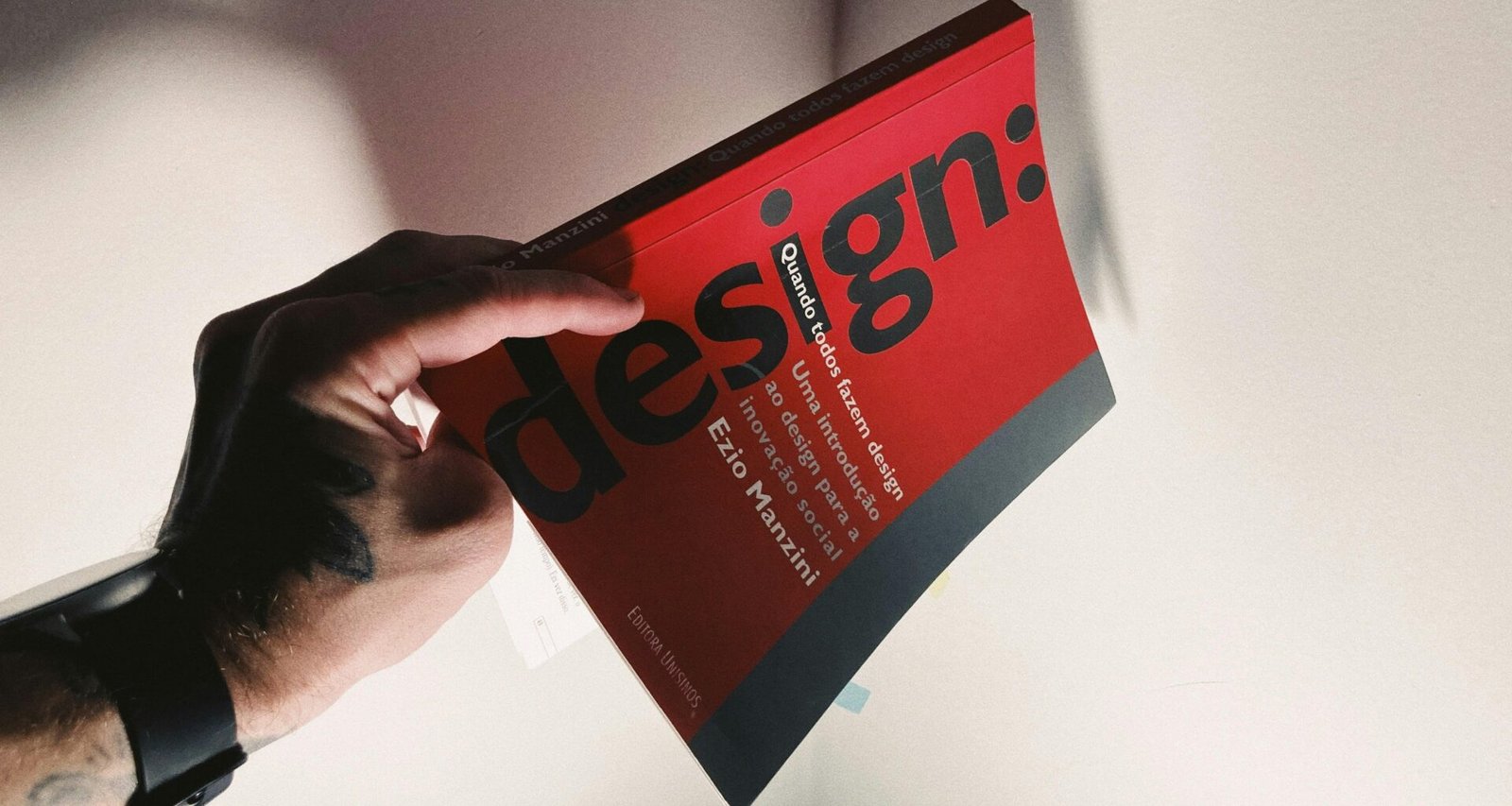 Eine Person hält ein Buch in der Hand, das als Symbol für Wissen und Bildung im Kontext von Technologie und Online-Marketing steht.