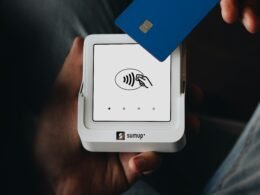 Eine Person hält eine Kreditkarte in der Hand, bereit für eine Online-Zahlung oder einen Einkauf im Internet.