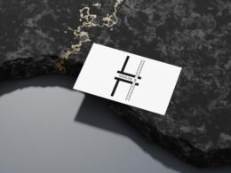 Eine einzelne Visitenkarte befindet sich auf einer strukturierten, leicht rauen Oberfläche und steht für Geschäftskontakte.