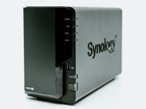 Graues Synology Netzwerk-Speichersystem auf einem Tisch, geeignet für Unternehmen und Privatnutzer im Technikbereich