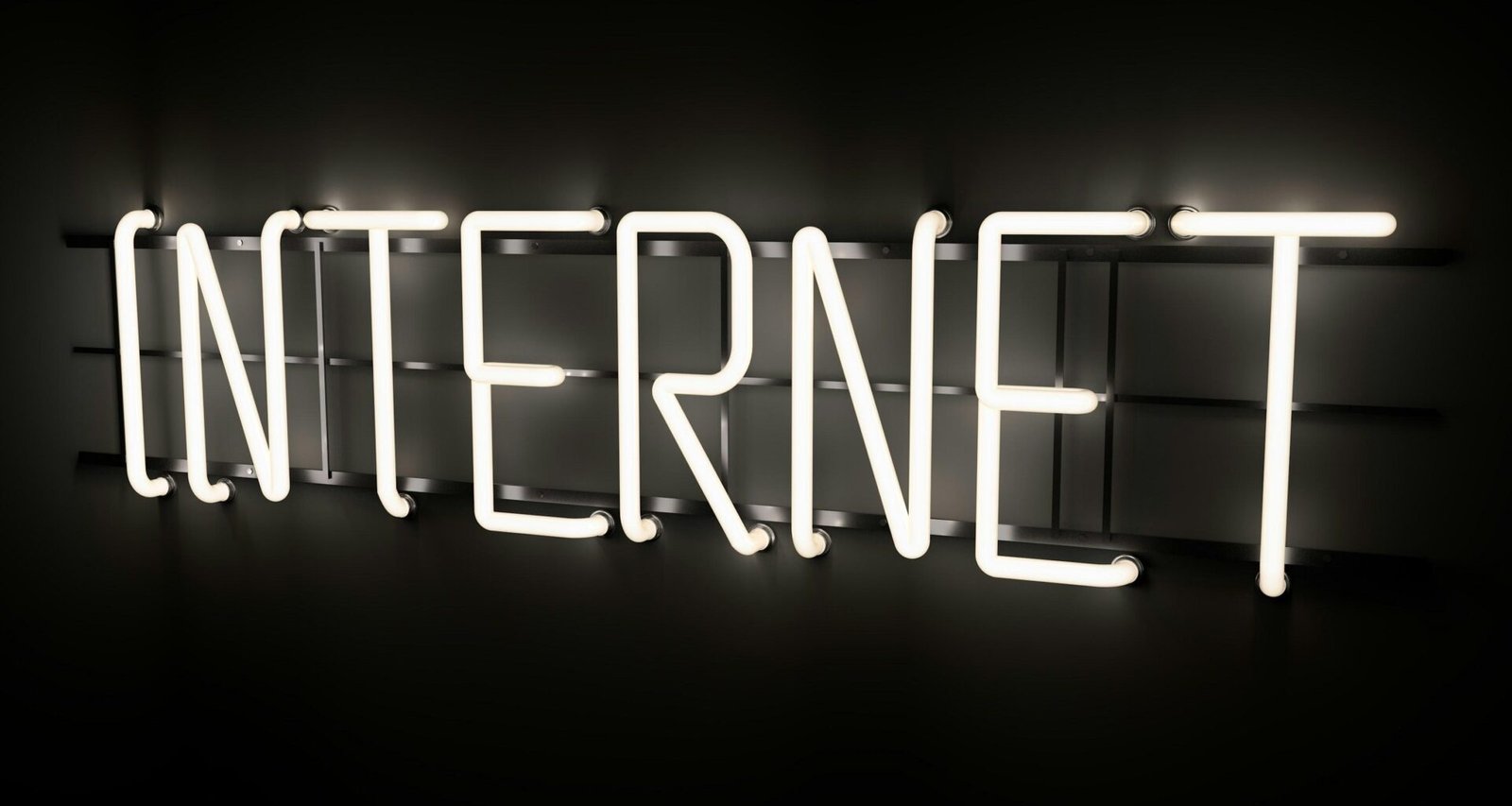 Leuchtender Neon-Schriftzug mit dem Wort 'Internet' an einer Wand, Symbol für digitale Welt und moderne Technologien
