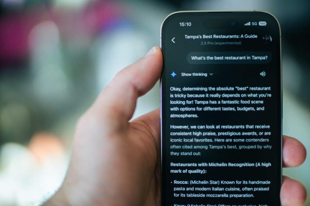 Person sucht mit dem Smartphone nach einem Restaurant und nutzt dabei eine Karten- oder Bewertungs-App