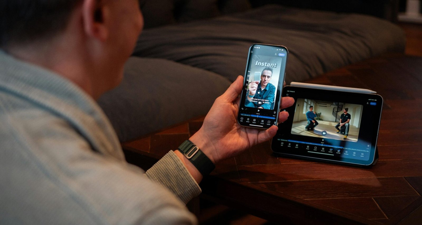 Ein Mann hält ein Smartphone in der Hand und schaut sich ein Video auf dem Bildschirm an, Alltagsszene digitaler Mediennutzung.