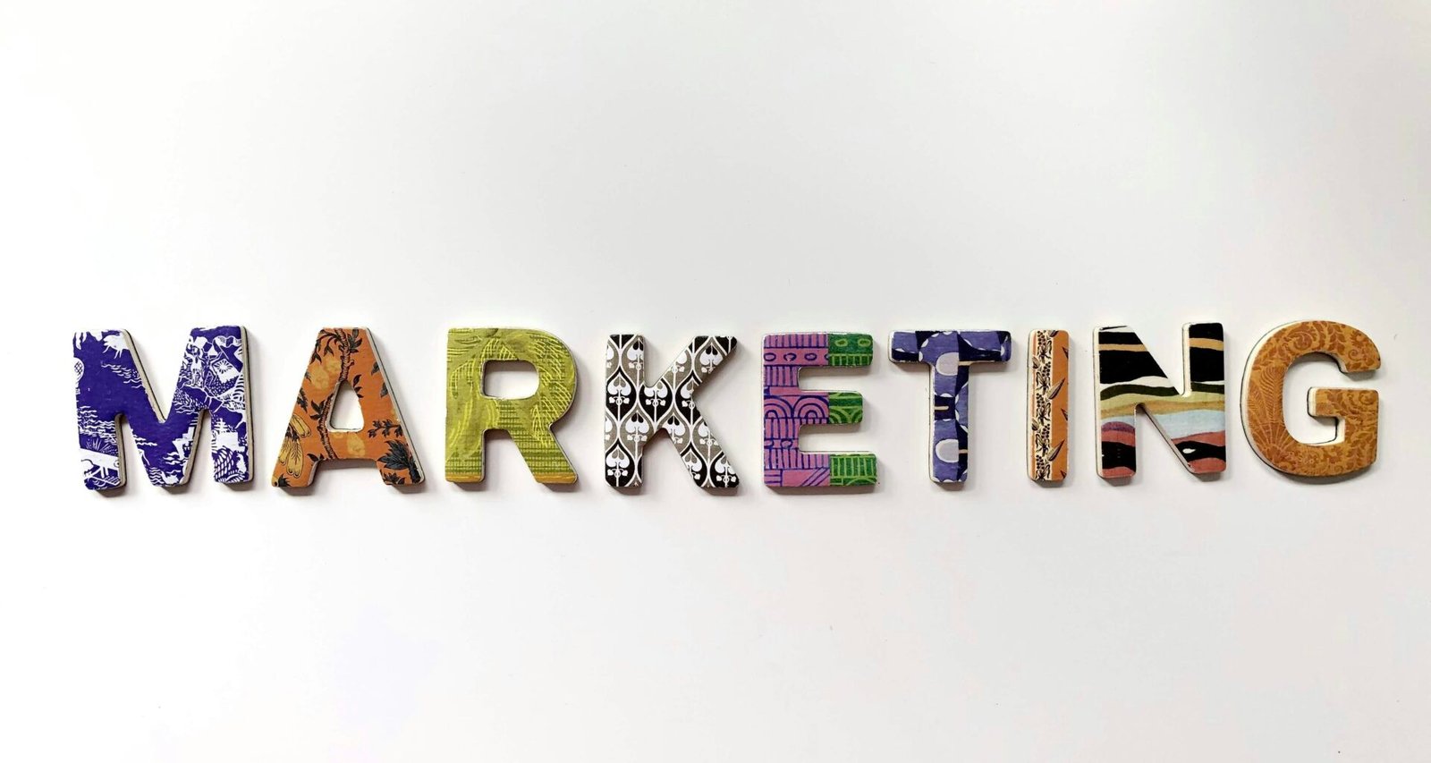 Freistehende, multicolored Buchstaben formen das Wort Marketing auf einer hellen Fläche als zentrales Motiv.