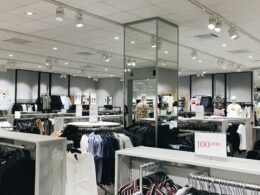 Mehrere Personen sitzen auf Stühlen in einem großen, modernen Gebäude zusammen und tauschen sich aus.