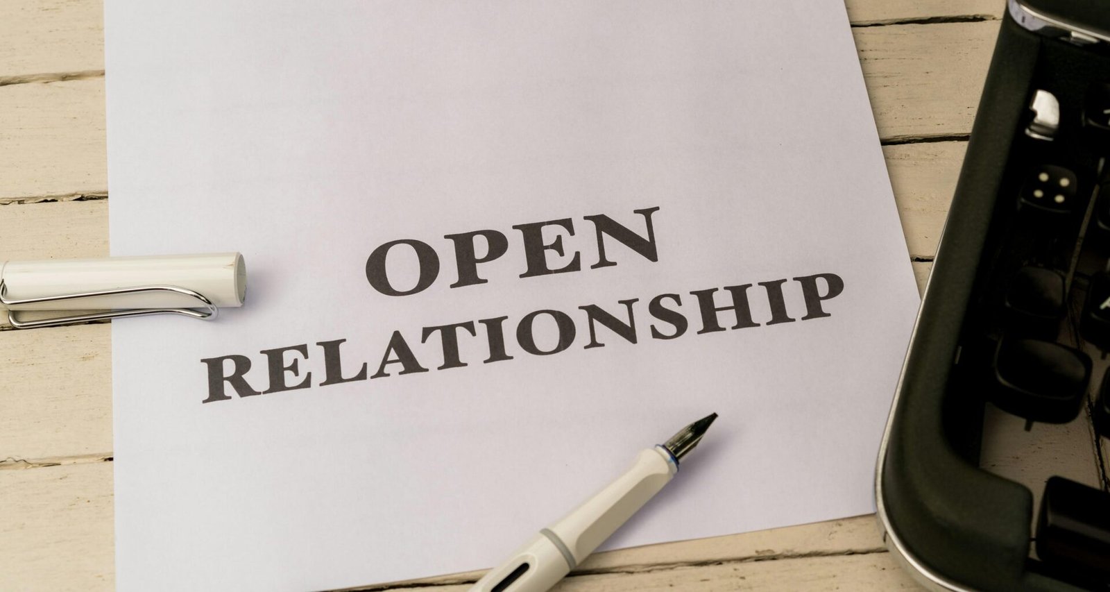 Nahaufnahme eines weißen Blatt Papiers mit einem schwarzen Kugelschreiber – klassisches Symbol für Schreibarbeit