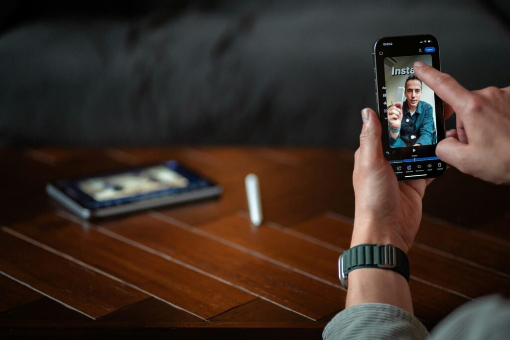 Eine Person hält ein Smartphone in der Hand und führt einen Videoanruf, der das Display deutlich im Mittelpunkt zeigt.