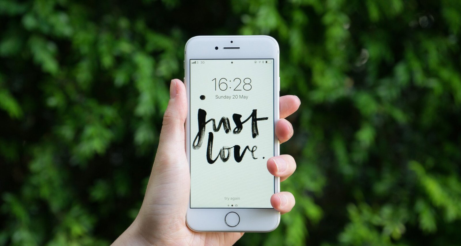 Nahaufnahme von einer Person, die ein silbernes iPhone 6 in der Hand hält, geeignet für Beiträge zu mobiler Technologie.