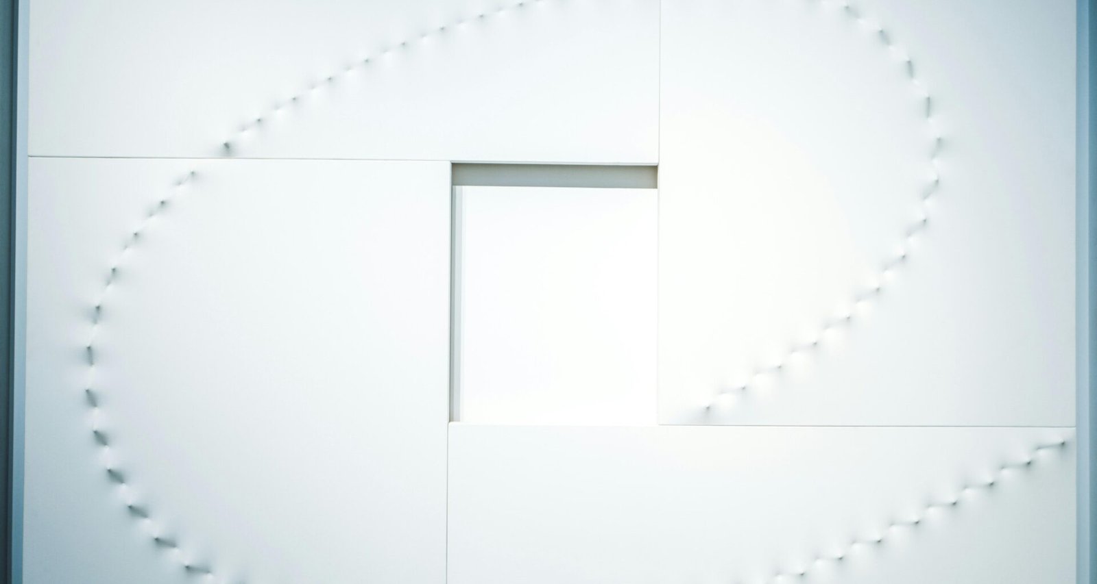 Quadratische Lochformation in gleichmäßiger Anordnung als Beispiel für modernes architektonisches Design.