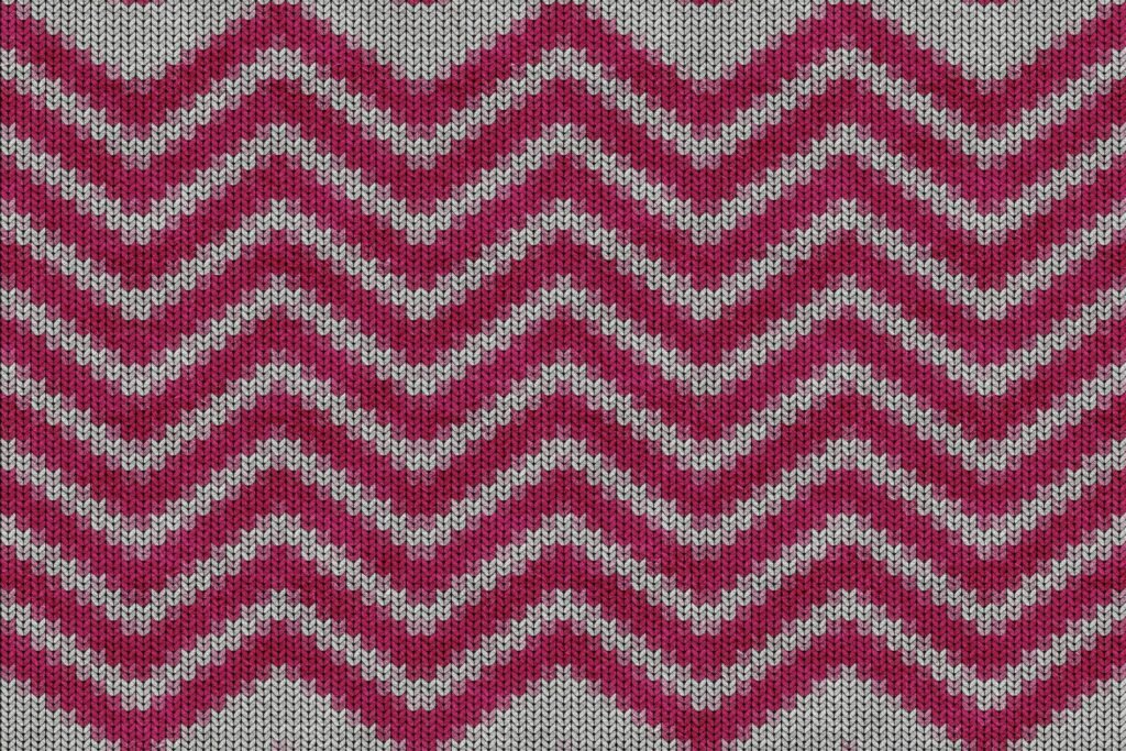 Nahaufnahme eines roten und weißen Chevron-Textilstücks mit klar sichtbarem Zackenmuster und strukturierter Oberfläche