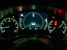 Schwarzweißfoto eines Instrumentenpanels in einem Auto mit Tacho, Drehzahlmesser und Anzeigen, fotografiert aus Fahrerperspektive