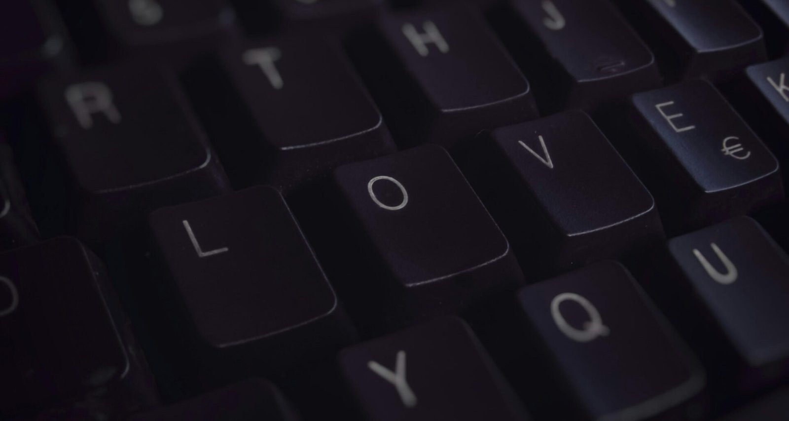 Schwarze Computertastatur mit klaren Buchstaben, Nahaufnahme der Tasten auf einem Schreibtisch