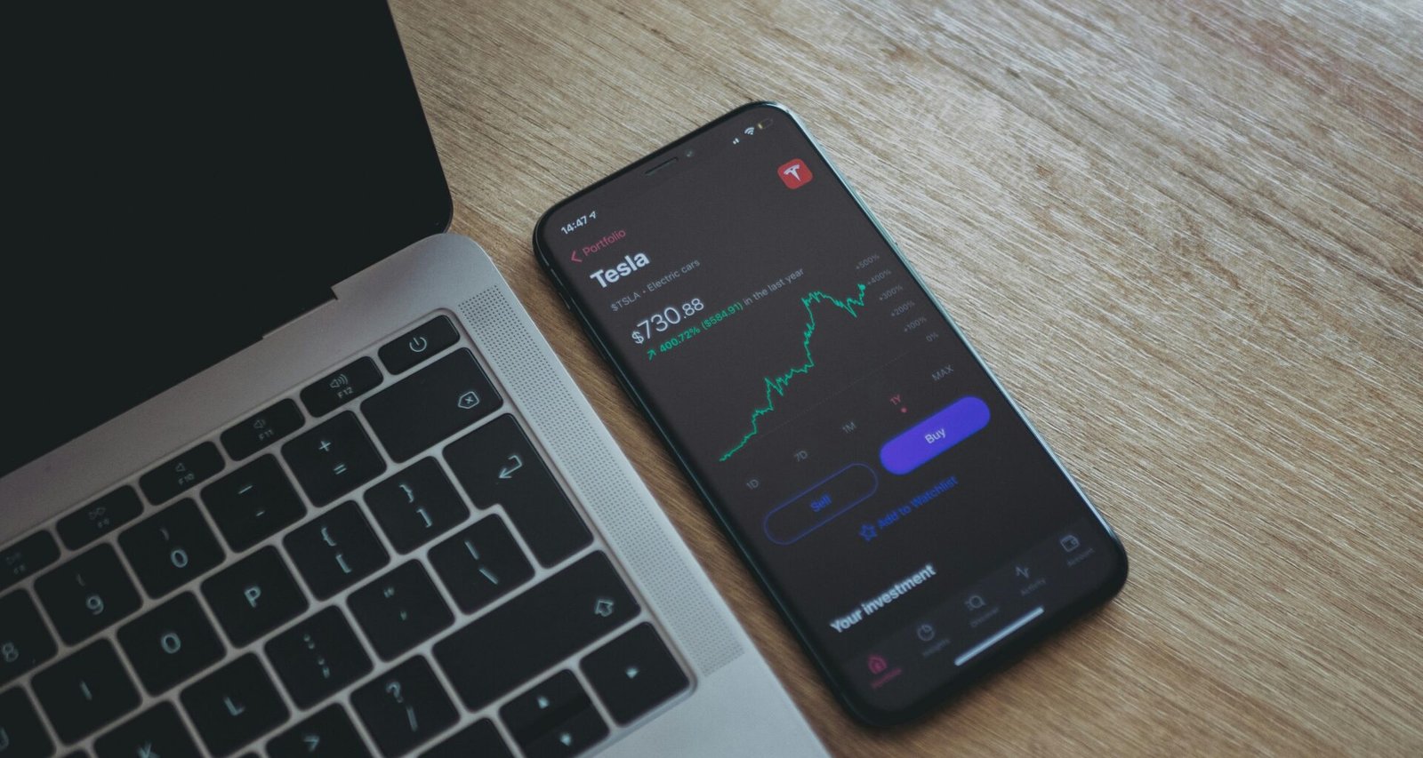 Schwarzes Android-Smartphone auf der Tastatur eines MacBook Pro, Fokus auf mobile und Computertechnologien im Büro