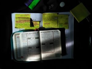 Gestapelte weiße Druckerpapierblätter auf einem schwarzen Tisch, geeignet für Büro, Homeoffice oder klassische Arbeitsumgebungen.