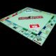 Monopoly-Brettspiel mit Spielfiguren und Karten auf schwarzem Hintergrund, symbolisch für Strategie und Wirtschaft